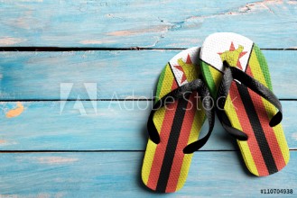 Bild på Thongs with flag of Zimbabwe on blue wooden boards